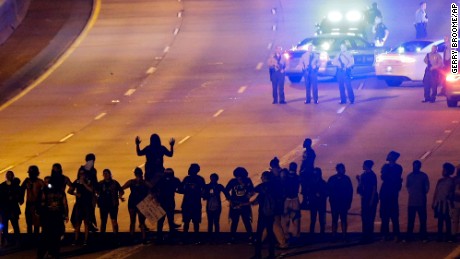 Protesters block I-277 during a third night of unrest following Tuesday's police shooting of Keith Lamont Scott in Charlotte, N.C., Thursday, Sept. 22, 2016. (AP Photo/Gerry Broome)