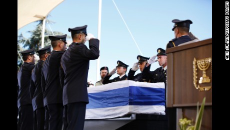 Knesset (Israel's parliament) guards salute as they place the coffin of former Israeli president Shimon Peres on a podium for his funeral on September 30, 2016, at Jerusalem's Mount Herzl national cemetery.
World leaders including US President Barack Obama and Prince Charles were bidding farewell to Israeli ex-prime minister and Nobel Peace Prize winner Shimon Peres as his funeral began under massive security. / AFP / POOL / ABIR SULTAN        (Photo credit should read ABIR SULTAN/AFP/Getty Images)