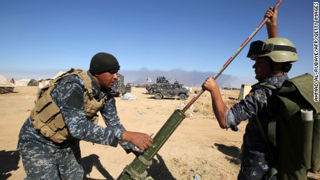 Iraqi policemen clean a weapon at the Qayyarah military base, about 60 kilometres (35 miles) south of Mosul, on October 16, 2016, as they prepare for an offensive to retake Mosul, the last IS-held city in the country, after regaining much of the territory the jihadists seized in 2014 and 2015. / AFP / AHMAD AL-RUBAYE        (Photo credit should read AHMAD AL-RUBAYE/AFP/Getty Images)