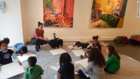 Children of market traders enjoy an art class. 