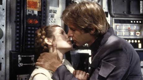Carrie Fisher and Harrison Ford kiss in a scene from "The Empire Strikes Back."