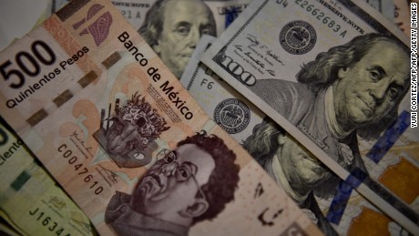 Bank notes of Mexican pesos and US Dollars are pictured in Mexico City, on November 8, 2016. The dollar tumbled against the yen and euro while the Mexican peso fell off a cliff as polling results in the knife-edge US presidential race pointed to a strong showing by Donald Trump. / AFP / YURI CORTEZ        (Photo credit should read YURI CORTEZ/AFP/Getty Images)