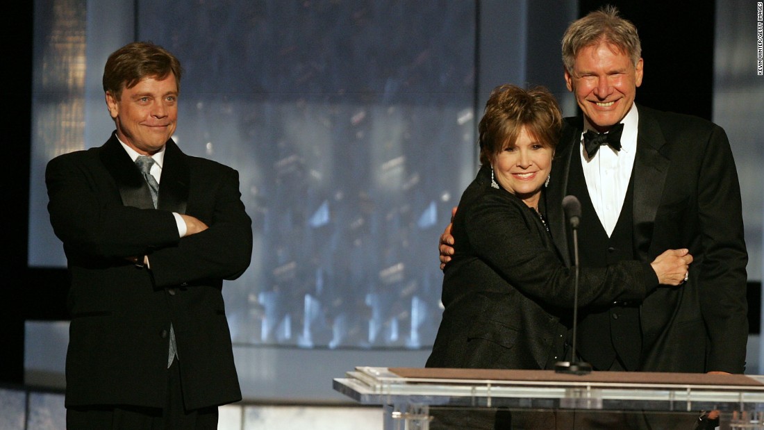&quot;Star Wars&quot; trio Mark Hamill, left, Fisher and Harrison Ford speak during a tribute to filmmaker George Lucas at the 33rd American Film Institute Life Achievement Award event in Hollywood on June 9, 2005.
