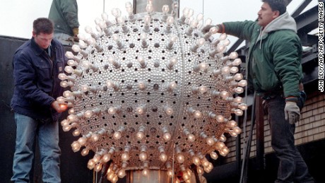 NEW YORK, UNITED STATES:  Workers prepare the 180 halogen lamps and 144 Xenon glitter strobes on the 500 pound Times Square New Year ball 30 December high above Times Square in New York. As tradition has it the ball will drop 70 feet on a flag pole as it counts down the last seconds of 1997 for the New Year. AFP PHOTO/Jon LEVY (Photo credit should read JON LEVY/AFP/Getty Images)
