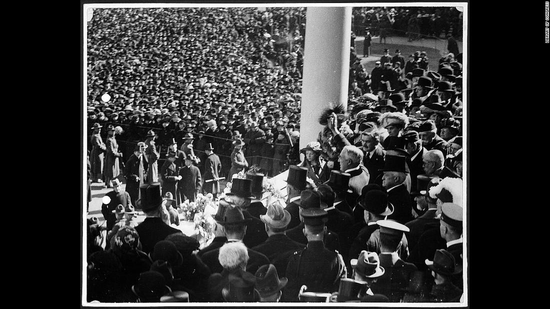 President Warren G. Harding waves to the crowd from the US Capitol&#39;s east portico in 1921. It was the first inauguration where an automobile was used to transport the president-elect to the Capitol.