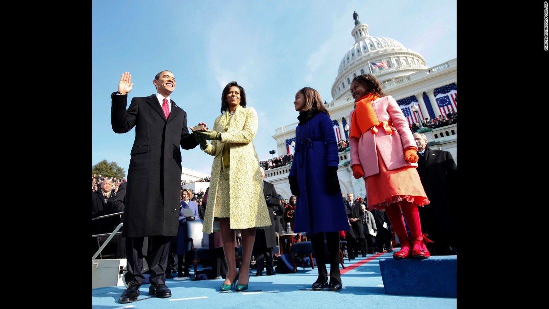 Barack Obama takes the oath of office in 2009. His wife, Michelle, is holding the Bible, and they are joined by their daughters, Malia and Sasha. An estimated 1.5 million people attended the inauguration as Obama became the nation&#39;s first African-American president.