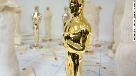 A 24-karat gold Oscar statuette stands among unfinished bronze Oscar statuettes January 13, 2017 at Polich Tallix Foundary in Rock Tavern, Upstate New York. 
A stylized figure of a knight holding a crusader&#39;s sword standing on a reel of film with five spokes signifying the five original branches of the Academy (actors, directors, producers, technicians and writers) is widely considered the most prestigious cinema award trophy. / AFP / Don EMMERT        (Photo credit should read DON EMMERT/AFP/Getty Images)