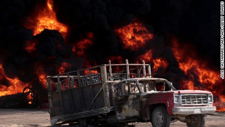 View of a burnt truck following the explosion of a petrol pipeline caused by fuel theft, in Acatzingo, Puebla State, on March 7, 2017.  / AFP PHOTO / JOSE CASTAÑARES        (Photo credit should read JOSE CASTANARES/AFP/Getty Images)