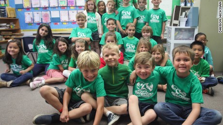 Ryan and his classmates with Ryan&#39;s Recycling Company T-shirts.