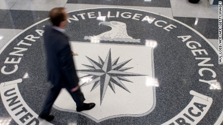 A man crosses the Central Intelligence Agency (CIA) logo in the lobby of CIA Headquarters in Langley, Virginia, on August 14, 2008. 