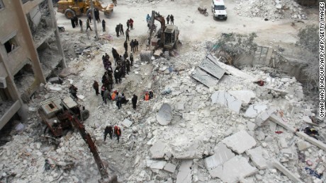 Rescuers search for victims after an air strike in the Syrian city of Idlib on March 15, 2017. Russia has propped up President Bashar al-Assad&#39;s with air power.