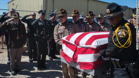 Officers from the Navajo Nation Police Department and the McKinley County Sheriff&#39;s Department carry the casket of fallen Navajo Nation Police Officer Houston Largo at Sunset Memorial Park in Gallup, N.M., Thursday, March 16, 2017. The 27-year-old decorated officer was shot while responding to a domestic violence call in remote New Mexico. (Cayla Nimmo/Gallup Independent via AP)