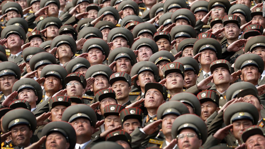 Soldiers salute while the national anthem is played during the parade.