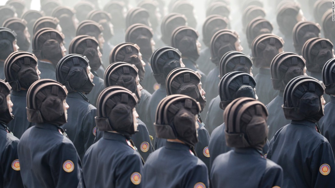 Helmeted servicemen march during the parade. 