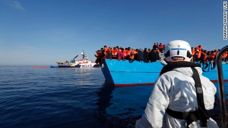 Ships from the humanitarian organization Migrant Offshore Aid Station approach a boat migrants in the middle of the Mediterranean Sea on April 15. 