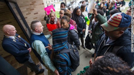 Police and officials block protesters from a University of Notre Dame hall where Charles Murray was speaking March 28. 