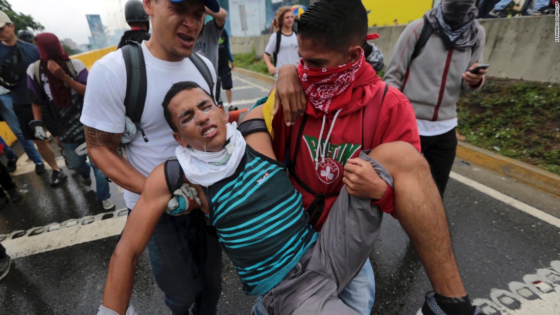 A protester suffering from the effects of tear gas is carried away on Thursday, April 13.