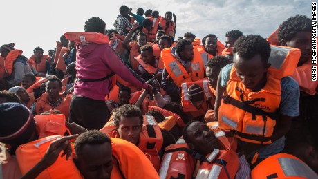 LAMPEDUSA, ITALY - MAY 24:  Refugees and migrants put on life jackets  distributed by rescue crews of the Migrant Offshore Aid Station (MOAS) &#39;Phoenix&#39; vessel on May 24, 2017 off Lampedusa, Italy. The boat, one of three  in the area later capsized killing more than 30 people, crewmembers from the &#39;Phoenix&#39; rescued 603 people. Numbers of refugees and migrants attempting the dangerous central Mediterranean crossing from Libya to Italy has risen since the same time last year with more than 43,000 people recorded so far in 2017. In an attempt to slow the flow of migrants Italy recently signed a deal with Libya, Chad and Niger outlining a plan to increase border controls and add new reception centers in the African nations, which are key transit points for migrants heading to Italy. MOAS is a Malta based NGO dedicated to providing professional search-and-rescue assistance to refugees and migrants in distress at sea. Since the start of the year MOAS have rescued and assisted 3572 people and are currently patrolling and running rescue operations in international waters off the coast of Libya.  (Photo by Chris McGrath/Getty Images)