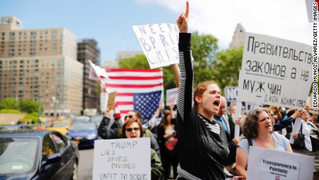 Demonstrators take part in an anti-Trump &quot;March for Truth&quot; rally at Foley Square on June 3, 2017 in New York City. The sign in Russian reads, &quot;Government of Laws, not men&quot; - John Adams.
