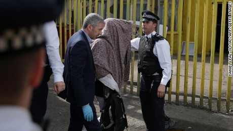 Police officers escort a person, with their head covered, to a police van, in Barking, east London on June 5, 2017, following a dawn raid on a property (R), as thier investigations continue following the June 3 terror attacks in central London.
Police carried out fresh raids and arrested &quot;a number of people&quot; on Monday after the Islamic State group claimed an attack by three men who mowed down and stabbed revellers in London on June 3, killing seven people, before being shot dead by officers. / AFP PHOTO / Daniel LEAL-OLIVAS        (Photo credit should read DANIEL LEAL-OLIVAS/AFP/Getty Images)