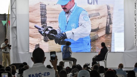 UN Secretary-General's Special Representative for Colombia and Head of the UN Mission to Colombia, Jean Arnault (C-L), and Revolutionary Armed Forces of Colombia (FARC) commander Pablo Catatumbo (C-R) look at a screen during a ceremony as part of the peace process in Buenos Aires, Cauca Department, Colombia on June 13, 2017. 
Colombia's Marxist FARC rebels handed in rifles and grenade launchers Tuesday in what were described as meaningful strides toward a deadline for a total surrender of arms within one week. / AFP PHOTO / RAUL ARBOLEDA        (Photo credit should read RAUL ARBOLEDA/AFP/Getty Images)