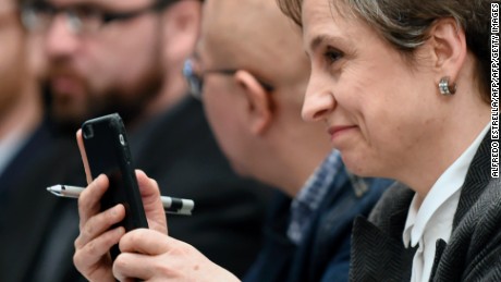 Mexican journalist Carmen Aristegui holds her mobile phone during a journalists' press conference in Mexico City on June 19, 2017, on an article published by the New York Times: "Using Texts as Lures, Government Spyware Targets Mexican Journalists and Their Families". / AFP PHOTO / ALFREDO ESTRELLA        (Photo credit should read ALFREDO ESTRELLA/AFP/Getty Images)