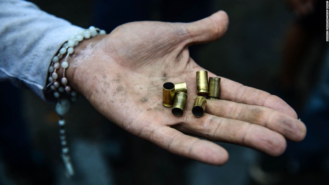 An opposition activist displays bullet shells during an anti-government demonstration on Monday, June 19.