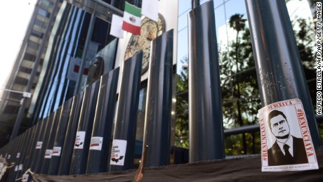 Stickers with the image of Mexican President Enrique Pena Nieto are stuck on columns outside the building of the attorney general's office during a protest against alleged government spying on journalists and human rights defenders in Mexico City on June 23, 2017. 
Mexican prosecutors said Wednesday they have opened an investigation into allegations the government spied on leading journalists, human rights activists and anti-corruption campaigners. / AFP PHOTO / ALFREDO ESTRELLA        (Photo credit should read ALFREDO ESTRELLA/AFP/Getty Images)