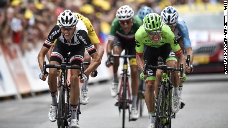 TOPSHOT - France's Warren Barguil (L) and Colombia's Rigoberto Uran (R) cross the finish line at the end of the 181,5 km ninth stage of the 104th edition of the Tour de France cycling race on July 9, 2017 between Nantua and Chambery. / AFP PHOTO / Jeff PACHOUD        (Photo credit should read JEFF PACHOUD/AFP/Getty Images)
