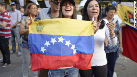 Opposition activists celebrate outside polling stations after taking part in an opposition-organized vote to measure public support for Venezuelan President Nicolas Maduro's plan to rewrite the constitution in Caracas on July 16, 2017.
Authorities have refused to greenlight the vote that has been presented as an act of civil disobedience and supporters of Maduro are boycotting it. Protests against Maduro since April 1 have brought thousands to the streets demanding elections, but has also left 96 people dead, according to an official toll.  / AFP PHOTO/AFP/Getty Images