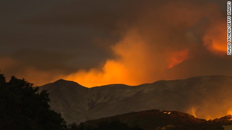 The Whittier Fire burns through the night on July 9, 2017 near Santa Barbara, California. The Whittier Fire and the Alamo Fire together have blackened more than 30,000 acres of chaparral-covered hills in Ventura County. Statewide, about 5,000 firefighters are fighting 14 large wildfires. 
