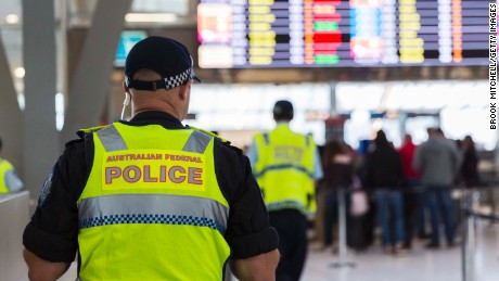 SYDNEY, NEW SOUTH WALES - JULY 30:  Police guard the passenger security check area at Sydney Airport on July 30, 2017 in Sydney, Australia. Counter terrorism police raided four houses across Sydney on Saturday night and arrested four men over an alleged terror plot that involved blowing up an aircraft. Australian travellers have been warned to expect major delays at airports around the country with security screening measures ramped up following the raids.  (Photo by Brook Mitchell/Getty Images)