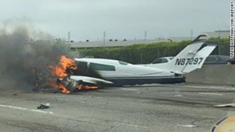 Drew Hoffman drove past a small plane that crashed on the 405 near John Wayne Airport in Santa Ana, California, on Friday.