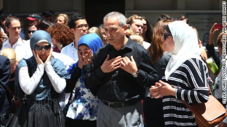 Muslim community leader Dr Jamal Rifi and family members lay a wreath at the makeshift memorial at Martin Place after the 2014 shootings at the Lindt coffee shop in Sydney&#39;s Martin Place. Sydney Australia.