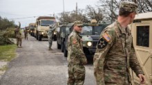 Soldiers with the National Guard patrol Rockport, looking for residents trapped in their homes.