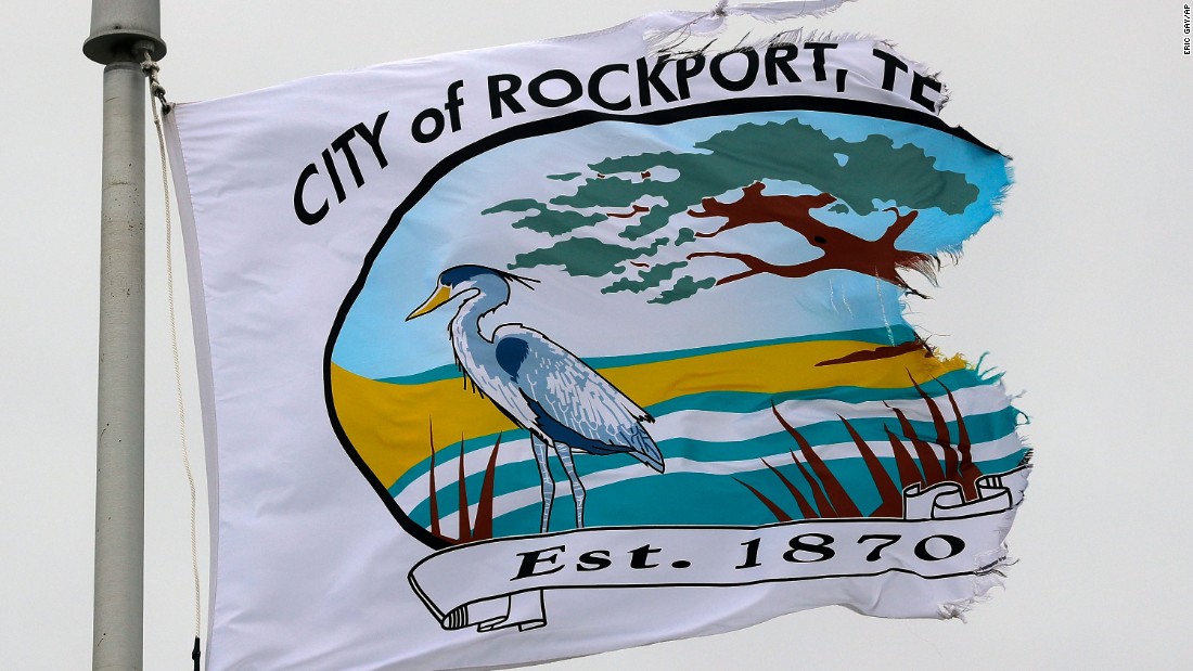 A city flag, tattered by the effects of Hurricane Harvey, flaps in the wind over the police station in Rockport on August 27.