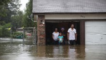 People wait to be rescued from their flooded home in Houston.