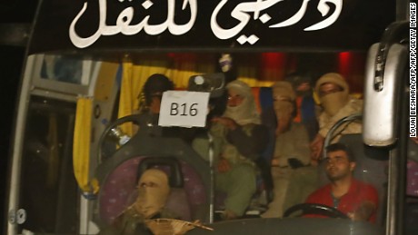 A bus carrying members of the Islamic State (IS) group leaves the Qara area in Syria's Qalamoun region on August 28, 2017 as the jihadists are transported to Deir Ezzor as part of an unprecedented deal to end three years of jihadist presence.
Under the evacuation deal, several hundred jihadists and their families on both sides of the border are set to leave by bus for Deir Ezzor in eastern Syria, the country's only province still under IS control. / AFP PHOTO / LOUAI BESHARA        (Photo credit should read LOUAI BESHARA/AFP/Getty Images)