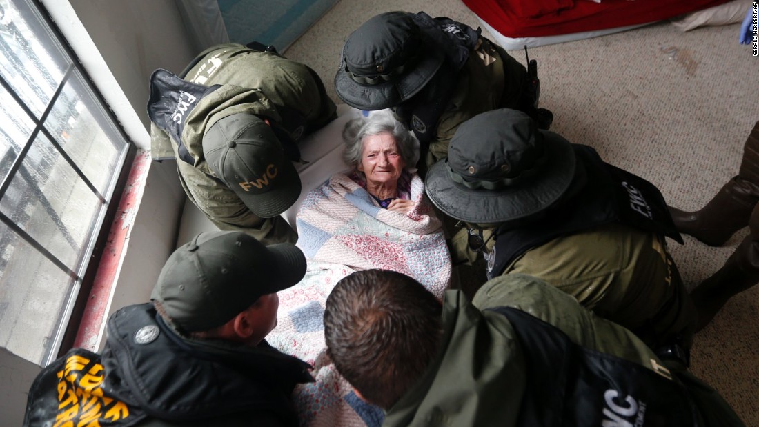 Members of the Louisiana Department of Wildlife and Fisheries, the Florida Fish and Wildlife Conservation Commission and the Louisiana National Guard help rescue elderly people from a flooded assisted living home in Orange, Texas, on August 30. 