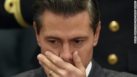 Mexican President Enrique Pena Nieto gestures as he listens to the President of the Human Rights National Commission, Luis Raul Gonzalez (out of frame), presenting the 2016 annual report on human rights in Mexico, at Los Pinos presidential palace in Mexico City, on March 31, 2017.  / AFP PHOTO / Pedro Pardo        (Photo credit should read PEDRO PARDO/AFP/Getty Images)