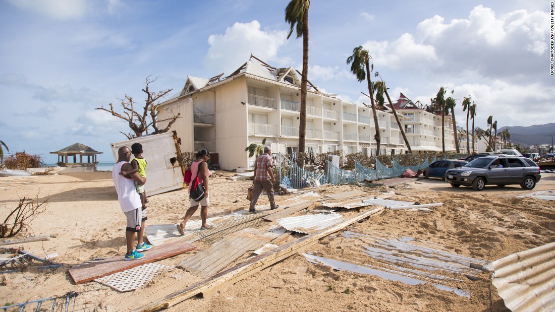 People walk through damage in Marigot, St. Martin, on September 7.