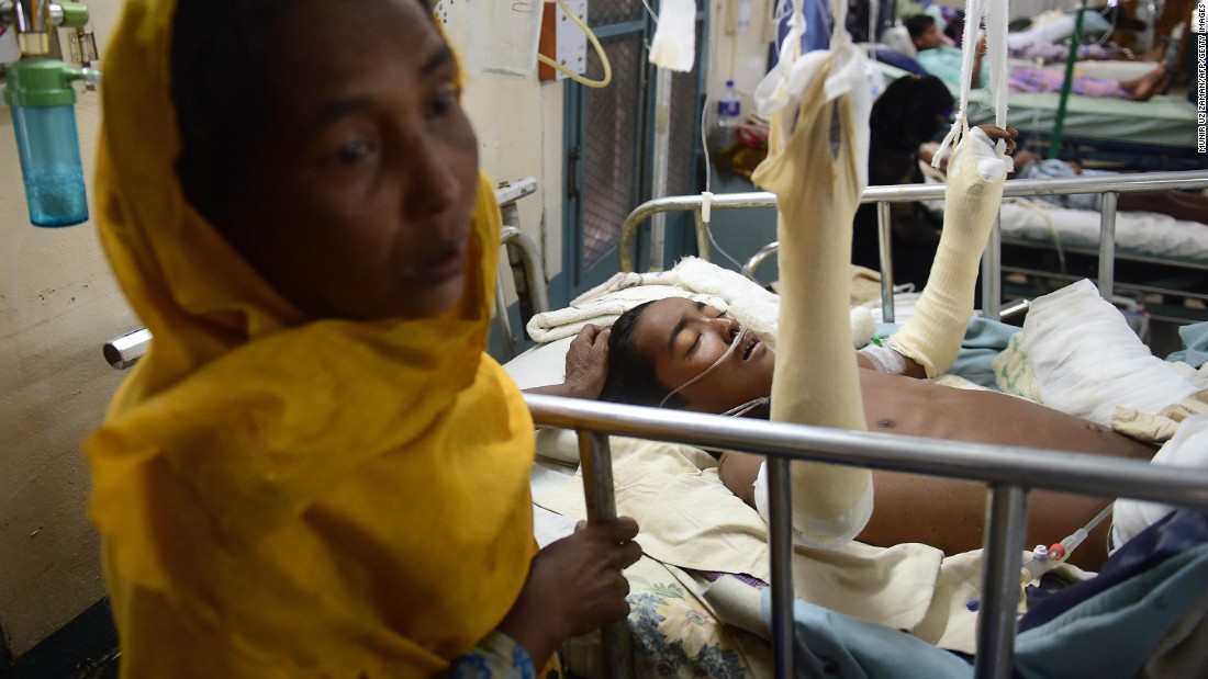 Rohingya refugee Rashida Begum stands next to her 15-year-old son, Azizul Hoque, as he is treated on September 13, at a hospital in Cox&#39;s Bazar, Bangladesh. He sustained a landmine injury while crossing from Myanmar to Bangladesh.