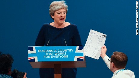 A protester interrupts Theresa May at the Conservative Party annual conference in Manchester on 4 October 2017.