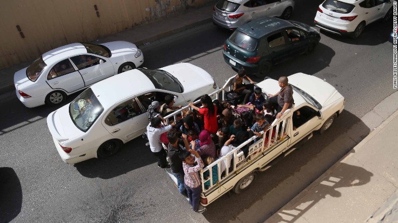 Families flee Kirkuk on the road to Erbil and Sulaymaniyah on Monday.