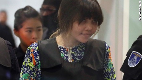 REMOVES REFERENCE TO RE-ENACTMENT - Vietnamese Doan Thi Huong is escorted by police as she arrives at Kuala Lumpur International Airport in Sepang, Malaysia, Tuesday, Oct. 24, 2017.  The two women accused of killing Kim Jong Nam, the North Korean leader&#39;s half brother, are touring at the Malaysian airport as participants in the murder trial visit the scene of the attack. (AP Photo/Sadiq Asyraf)