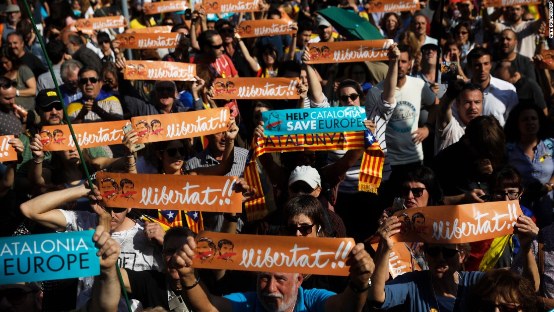 Protesters holds banners that read &#39;&#39;freedom&#39;&#39; in Catalan and include portraits of Jordi Sanchez and Jordi Cuixart, the imprisoned leaders of two Catalan grassroots organizations, during a rally outside the Catalan Parliament in Barcelona.