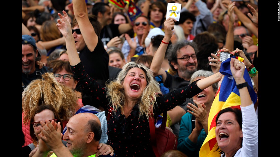 Maria Salut, 50, center, celebrates the unilateral declaration of independence of Catalonia outside the Catalan Parliament, in Barcelona, Spain.
