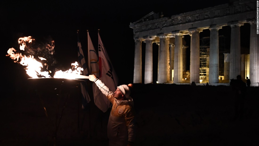 A succession of torchbearers carried the flame to the top of Acropolis Hill, where Greek gymnast Dimosthenis Tampakos (Olympic champion in the rings at Athens 2004) illuminated the columns of the Parthenon.