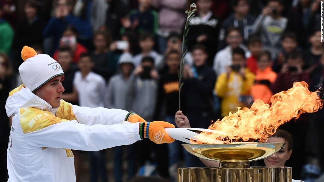After completing a week-long tour of Greece, the flame was officially passed to the PyeongChang organizing committee at a handover ceremony. Greek Alpine skier Ioannis Proios is shown holding the torch at the ceremony in Athens&#39; Panathenaic Stadium on October 31, 2017. 