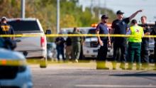 Law enforcement officials work the shooting scene.